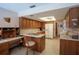 Traditional kitchen features wooden cabinetry, white appliances and tile flooring at 213 Stevenage Dr, Longwood, FL 32779