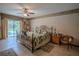 Comfortable main bedroom with a wrought iron bed frame, neutral walls, and backyard pool views at 213 Stevenage Dr, Longwood, FL 32779