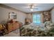 Cozy main bedroom features wicker furniture, large windows, and a view of the outdoor pool at 213 Stevenage Dr, Longwood, FL 32779
