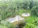 Community playground with swings, slides, and a sand area, surrounded by tall trees at 213 Stevenage Dr, Longwood, FL 32779