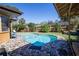 Backyard pool with a stone patio, privacy fence, lush landscaping, and lounge chairs at 213 Stevenage Dr, Longwood, FL 32779