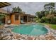 Kidney-shaped pool with flagstone decking and screened patio at 213 Stevenage Dr, Longwood, FL 32779