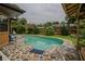 Refreshing kidney-shaped pool with flagstone decking and screened patio at 213 Stevenage Dr, Longwood, FL 32779