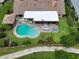 Aerial view of kidney-shaped pool with stone surround and a screened-in lanai with outdoor seating at 213 Stevenage Dr, Longwood, FL 32779