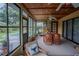 Enclosed sunroom with lots of light featuring a dining area, tile floors, and access to the pool at 213 Stevenage Dr, Longwood, FL 32779