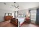 Bright main bedroom featuring hardwood floors, ceiling fan, and double windows at 17000 Se 76Th Creekside Cir, The Villages, FL 32162