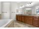 Elegant bathroom with double vanity and large soaking tub at 25499 Hawks Run Ln, Sorrento, FL 32776