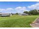 Expansive backyard showcasing lush green grass and well-manicured landscaping, perfect for outdoor activities at 17574 Se 106Th Ave, Summerfield, FL 34491