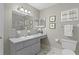 Bathroom with a large vanity, ample lighting, and a large mirror at 17574 Se 106Th Ave, Summerfield, FL 34491