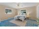 Inviting bedroom with ceiling fan, large windows, and comfortable furnishings at 17574 Se 106Th Ave, Summerfield, FL 34491