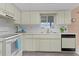 Functional kitchen with plenty of cabinet space and a window over the sink at 17574 Se 106Th Ave, Summerfield, FL 34491