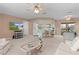 Open-concept living space with view of a kitchen featuring bar seating and a dining area at 17574 Se 106Th Ave, Summerfield, FL 34491