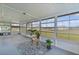 Bright sunroom featuring walls of windows, neutral decor and a stylish rug, creating a peaceful space at 17574 Se 106Th Ave, Summerfield, FL 34491