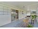 Enclosed sunroom boasts natural light, views, stylish furniture, and easy access to the indoors through a sliding glass door at 17574 Se 106Th Ave, Summerfield, FL 34491