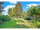Expansive backyard featuring mature trees and lush green grass offers a tranquil outdoor space at 20621 Se Highway 42, Umatilla, FL 32784