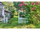 Charming backyard with white picket fence and a vibrant flowering tree adds character to the property at 20621 Se Highway 42, Umatilla, FL 32784