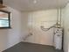 Unfinished basement features concrete block walls, window, and visible water heater at 20621 Se Highway 42, Umatilla, FL 32784