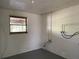 Unfinished basement space with concrete block walls and a small window to the exterior at 20621 Se Highway 42, Umatilla, FL 32784