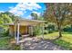 View of the carport, driveway, and partially obscured facade of the property at 20621 Se Highway 42, Umatilla, FL 32784