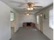Open living room with a fireplace, ceiling fan, and window to the exterior at 20621 Se Highway 42, Umatilla, FL 32784