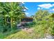 Enclosed porch provides a cozy space to relax while enjoying the view of the green, overgrown yard at 20621 Se Highway 42, Umatilla, FL 32784