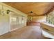 Spacious sunroom with sliding glass doors leading to another room and an exterior wall at 20621 Se Highway 42, Umatilla, FL 32784