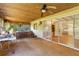 Enclosed sunroom with textured ceiling, carpet flooring, and sliding doors to the outside at 20621 Se Highway 42, Umatilla, FL 32784