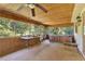 Sunroom with a ceiling fan, bamboo ceiling, and lots of natural light at 20621 Se Highway 42, Umatilla, FL 32784