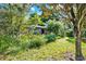 Residential house exterior with lush foliage and lots of shrubbery at 20621 Se Highway 42, Umatilla, FL 32784