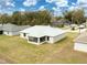 Aerial view of backyard featuring screened porch and the home's exterior at 8878 Se 158Th St, Summerfield, FL 34491