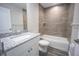 Bathroom featuring granite countertop, neutral tile, and a tub with shower at 8878 Se 158Th St, Summerfield, FL 34491