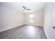 Bedroom with gray wood-look floors, neutral paint, and a ceiling fan at 8878 Se 158Th St, Summerfield, FL 34491