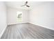 Light and airy bedroom with wood-look floors and a view from the window at 8878 Se 158Th St, Summerfield, FL 34491