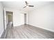 Bright bedroom featuring wood-look floors, a ceiling fan, and closet at 8878 Se 158Th St, Summerfield, FL 34491