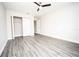 Bedroom featuring wood-look floors, a ceiling fan, and closet at 8878 Se 158Th St, Summerfield, FL 34491