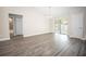 Open concept dining space featuring sliding glass doors, gray wood-look floors, and neutral paint at 8878 Se 158Th St, Summerfield, FL 34491