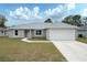 Charming front exterior of a single-story home with a well-manicured lawn at 8878 Se 158Th St, Summerfield, FL 34491