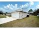 Garage exterior next to a home with green grass at 8878 Se 158Th St, Summerfield, FL 34491