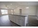 Kitchen island with granite countertops, white cabinets, and wood-look floors at 8878 Se 158Th St, Summerfield, FL 34491