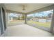 Screened porch with ceiling fan overlooking backyard at 8878 Se 158Th St, Summerfield, FL 34491