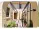 An inviting front entrance featuring manicured plants and a black metal gate at 1111 Lakeshore Dr # A3, Eustis, FL 32726