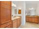 Large bathroom features granite countertop and wood cabinets at 3732 Barrel Loop, The Villages, FL 32163