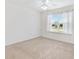 Bright bedroom with carpet flooring and a window at 3732 Barrel Loop, The Villages, FL 32163