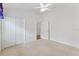 Bright bedroom with closet, ceiling fan, neutral carpet, white walls and white trim at 3732 Barrel Loop, The Villages, FL 32163