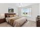 Bright bedroom featuring a ceiling fan, neutral color palette and a large window with natural light at 3732 Barrel Loop, The Villages, FL 32163