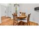 Bright dining room features wood floors and seating for four at 3732 Barrel Loop, The Villages, FL 32163