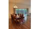 Dining room features wood floors, seating for eight, and sliding glass doors at 3732 Barrel Loop, The Villages, FL 32163