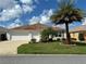 Single-story house with a two-car garage and palm trees at 3732 Barrel Loop, The Villages, FL 32163