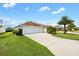 Attractive single-story home with well-manicured lawn and three-car garage at 3732 Barrel Loop, The Villages, FL 32163