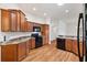 Kitchen with wood cabinets, granite countertops, and black appliances at 3732 Barrel Loop, The Villages, FL 32163